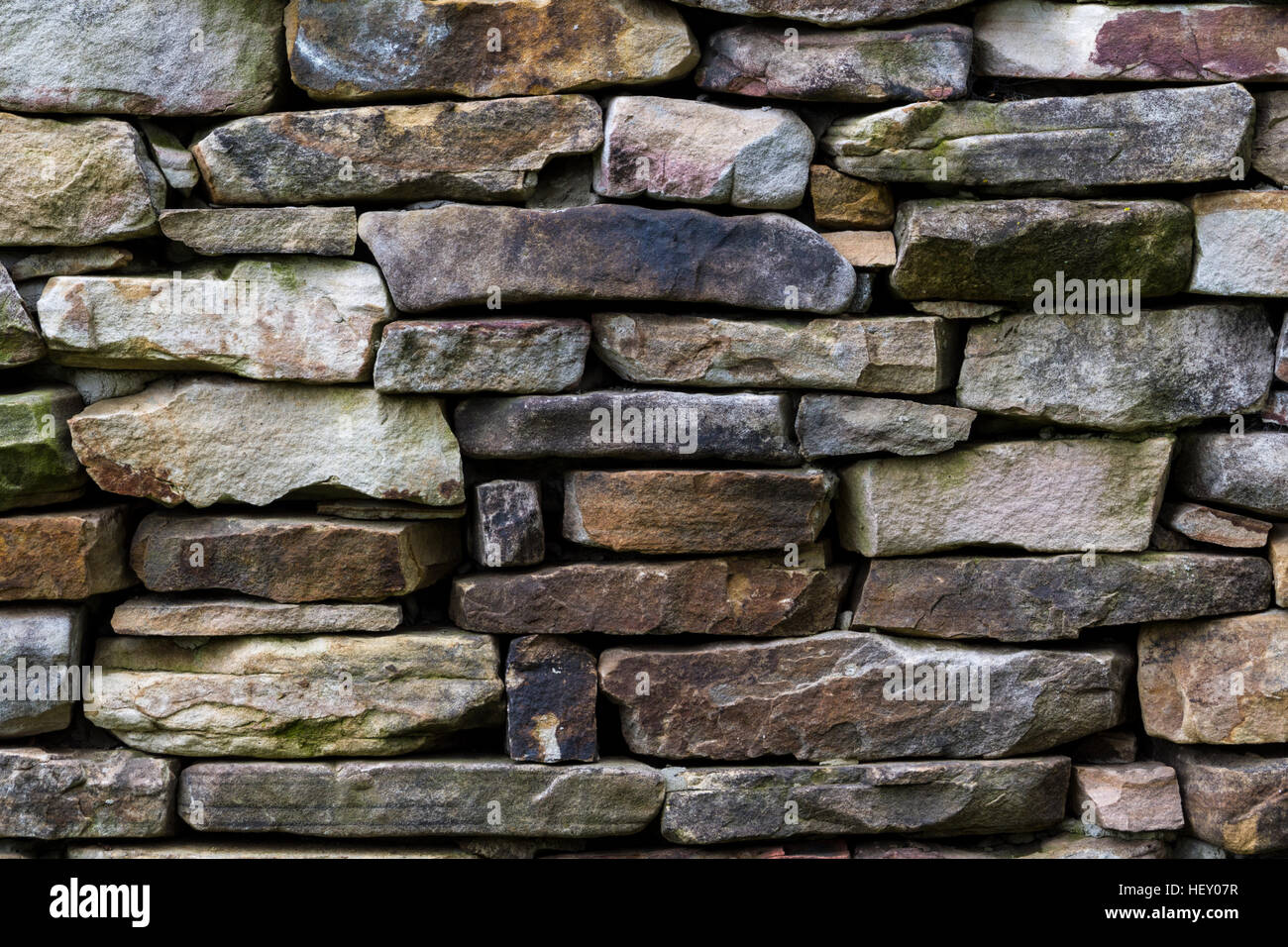 Stone wall pattern from old log cabin chimney. Stock Photo