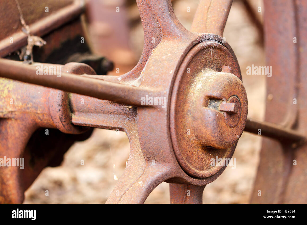 Close up of rusted wheel on abandoned farm equipment. Stock Photo