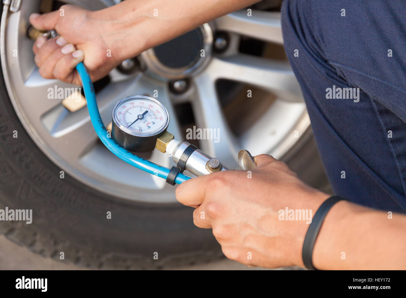 Hand holding pressure gauge for car tyre measurement Stock Photo Alamy