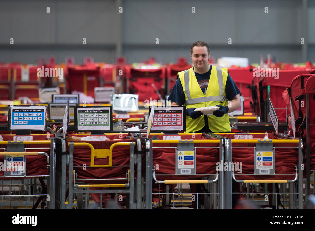 Royal Mail Christmas temp workers process Christmas mail at the Royal Mail Christmas sorting office in Llantrisant, South Wales, UK. Stock Photo