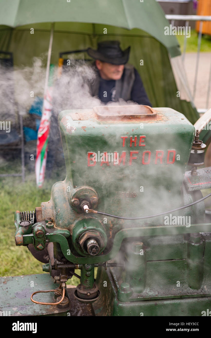 A vintage Stationary Engine, The Bamford, with its owner at a county show. Stock Photo