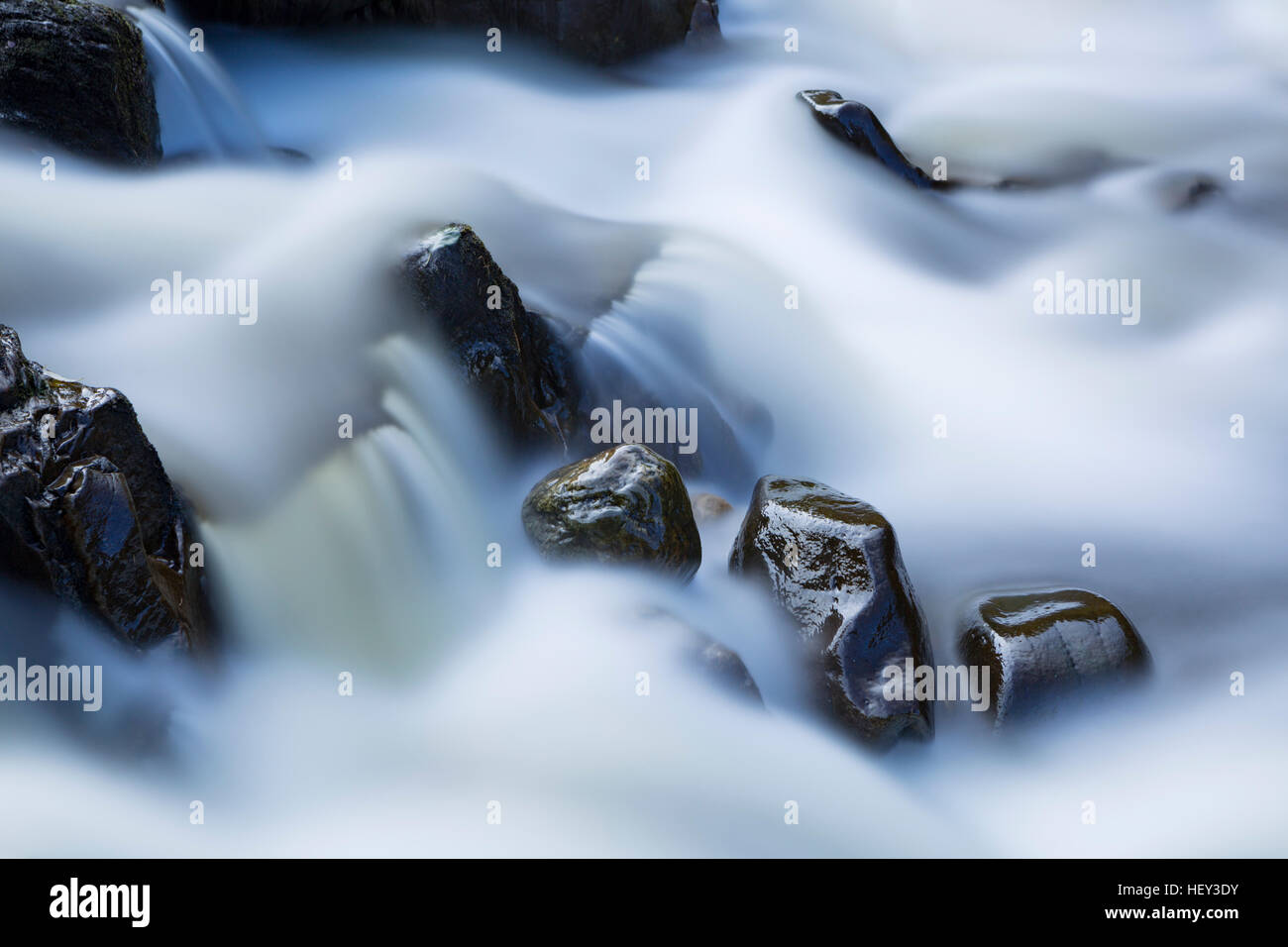 The River Braan is made silky smooth by using to a 90 second exposure to blur the water along the waterfall which accentuates the rocks. Stock Photo
