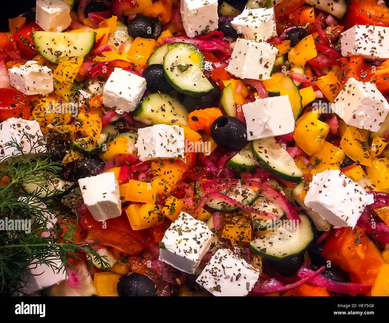 Salad of red and yellow bell peppers, black olives and feta cheese Stock Photo