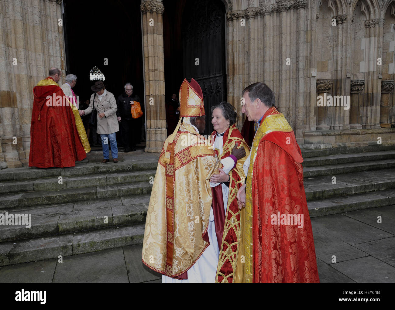 The Dean of York Minster Vivienne Faull talks to the Archbishop of York Dr John Sentamu (left) as they leave York Minster following the Christmas Day Service where the bells remained silent for the first time in over 650 years following the sacking of the bell ringers. Stock Photo
