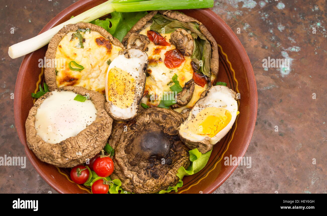 egg and cheese stuffed mushrooms on a vintage background Stock Photo