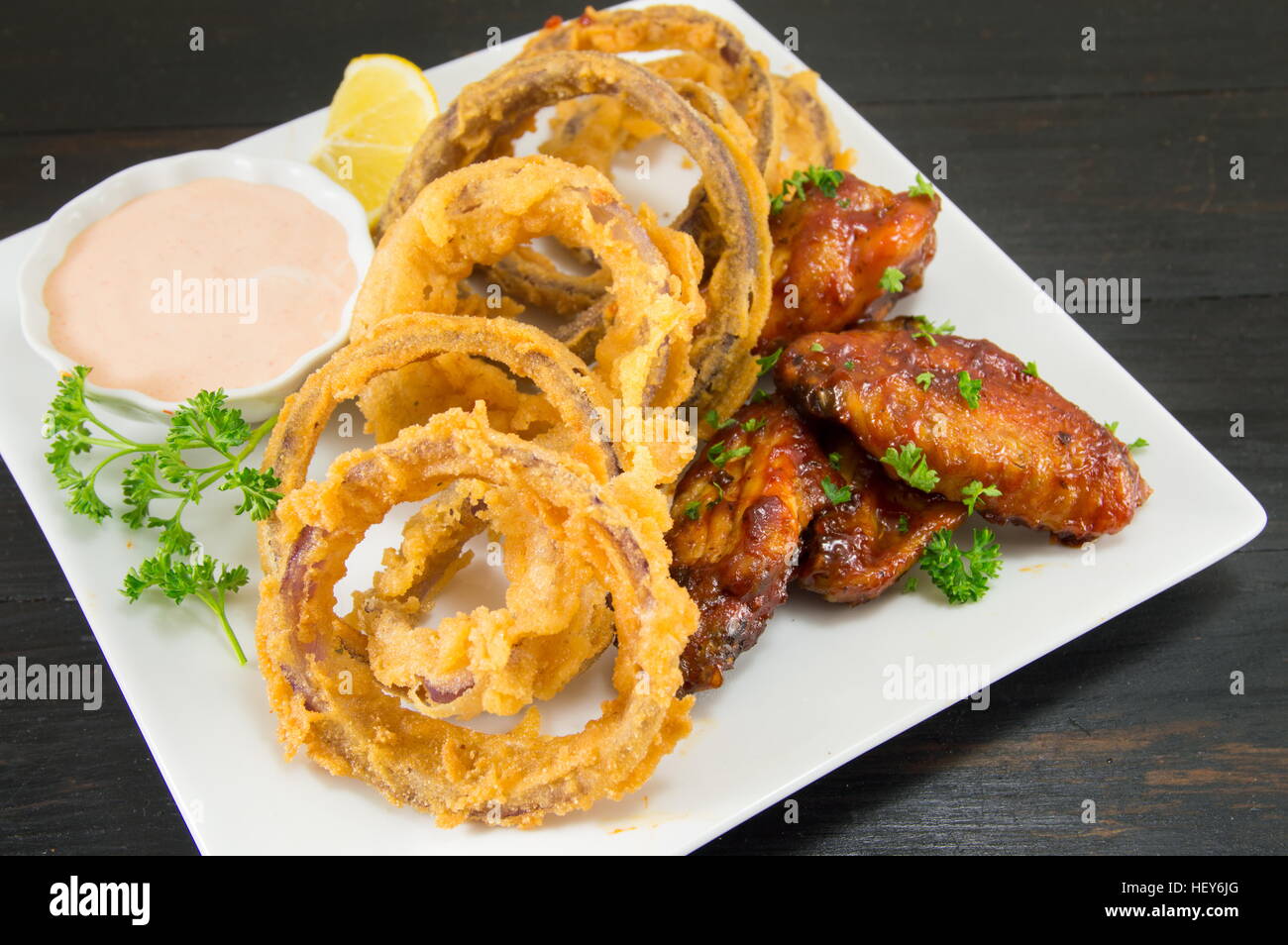 onion rings, barbecue wings and homemade dip Stock Photo