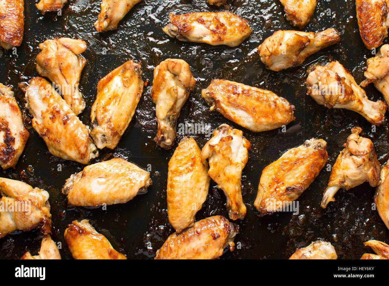 bbq chicken wings on a black baking plate Stock Photo