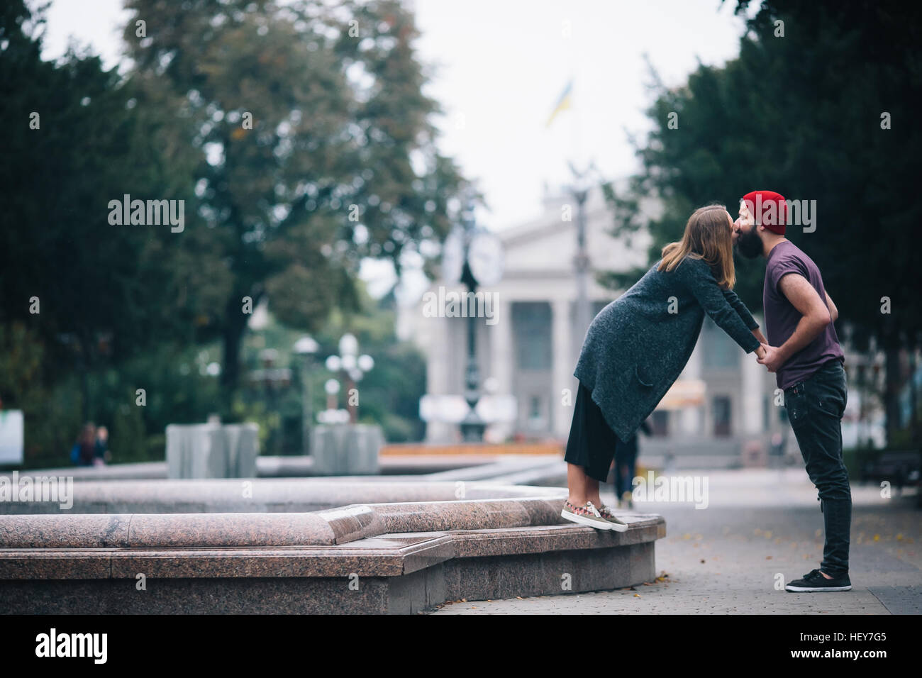 man and woman are kissing on the street Stock Photo - Alamy