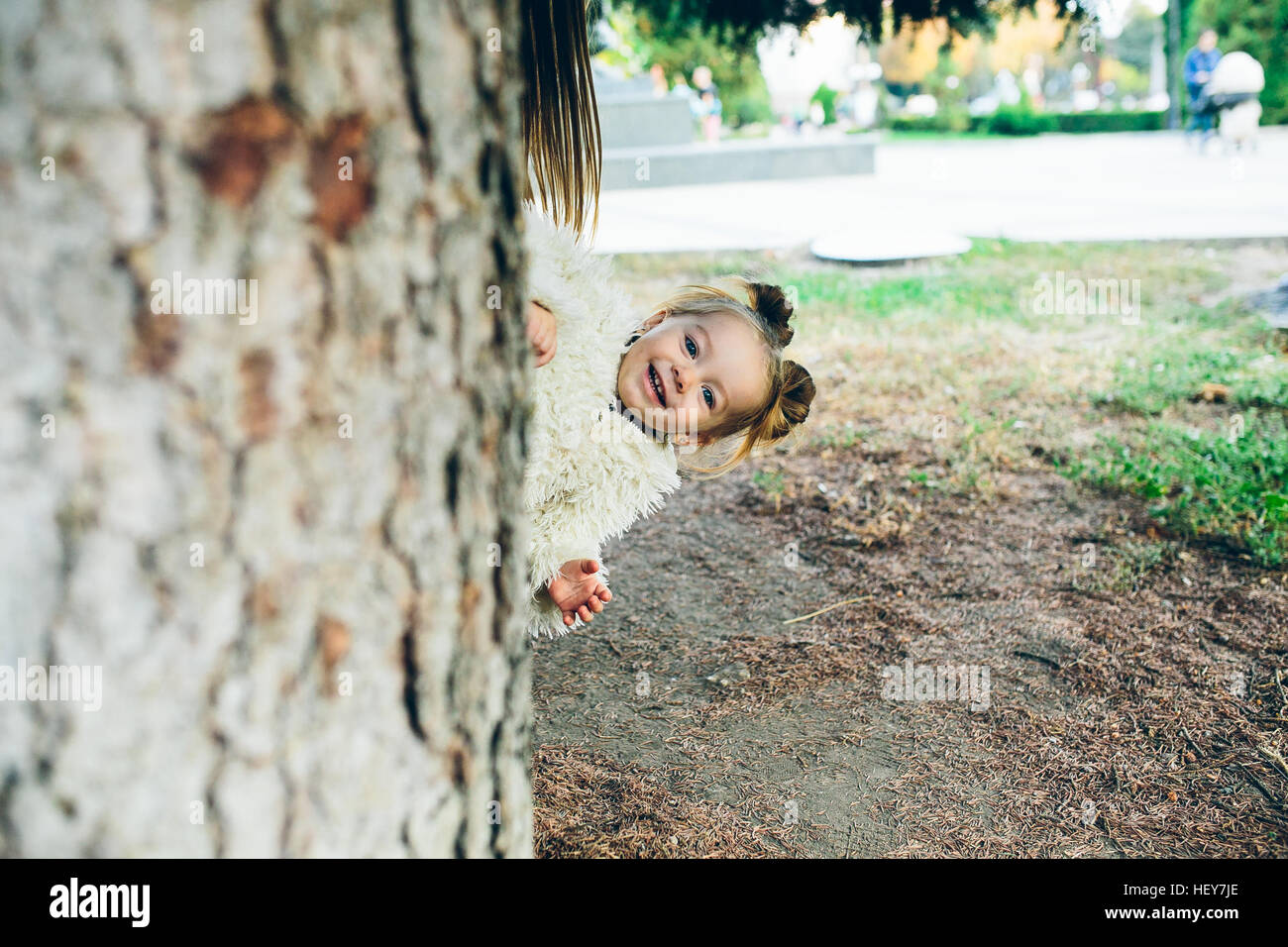 Cute little girl is playing outdoors Stock Photo - Alamy