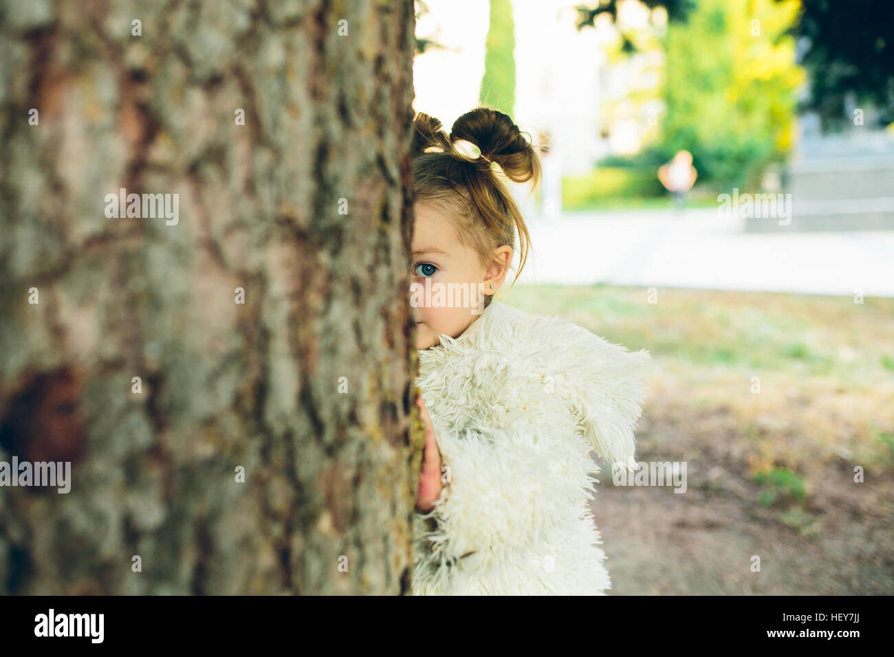 Cute little girl is playing outdoors Stock Photo - Alamy