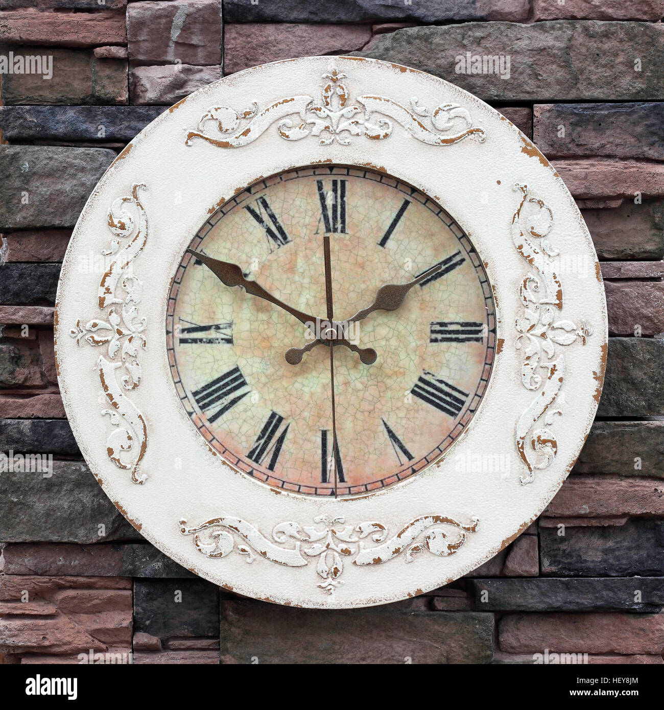 Clock Vintage mechanical wall clock on stone wall background Stock