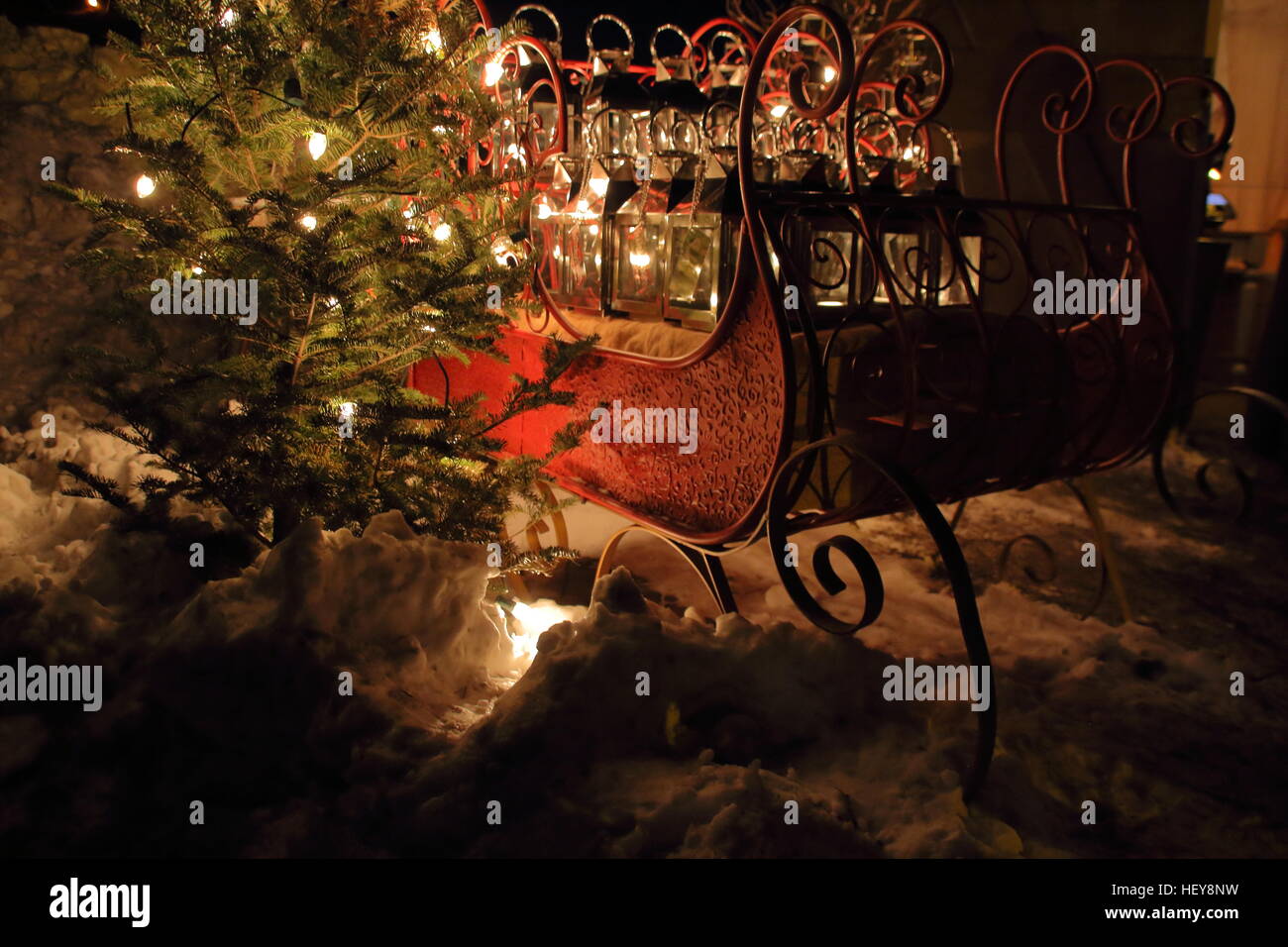 Sleigh filled with lanterns left of christmas tree on holiday nights Greenfield village, Detroit Stock Photo