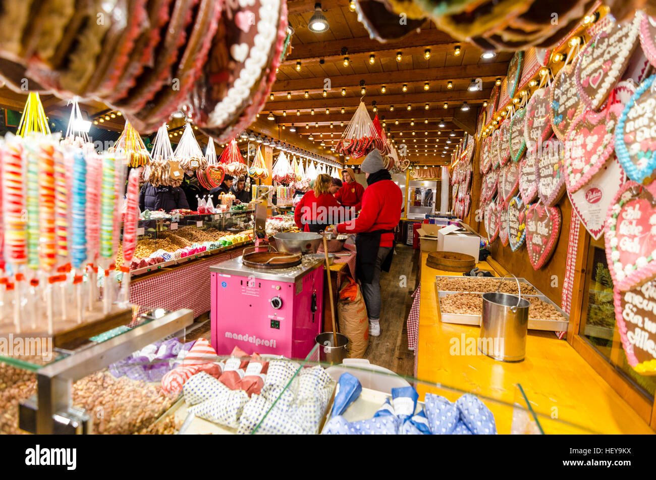 People serving at a sweets stall at a German Christmas market in Alexanderplatz, Berlin. Stock Photo