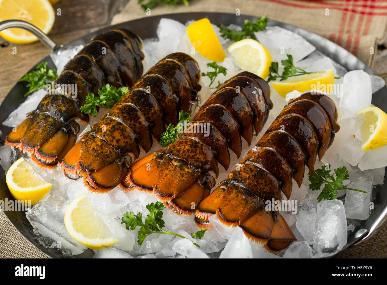 Raw Organic Fresh Lobster Tails with Lemon and Herb Stock Photo Alamy