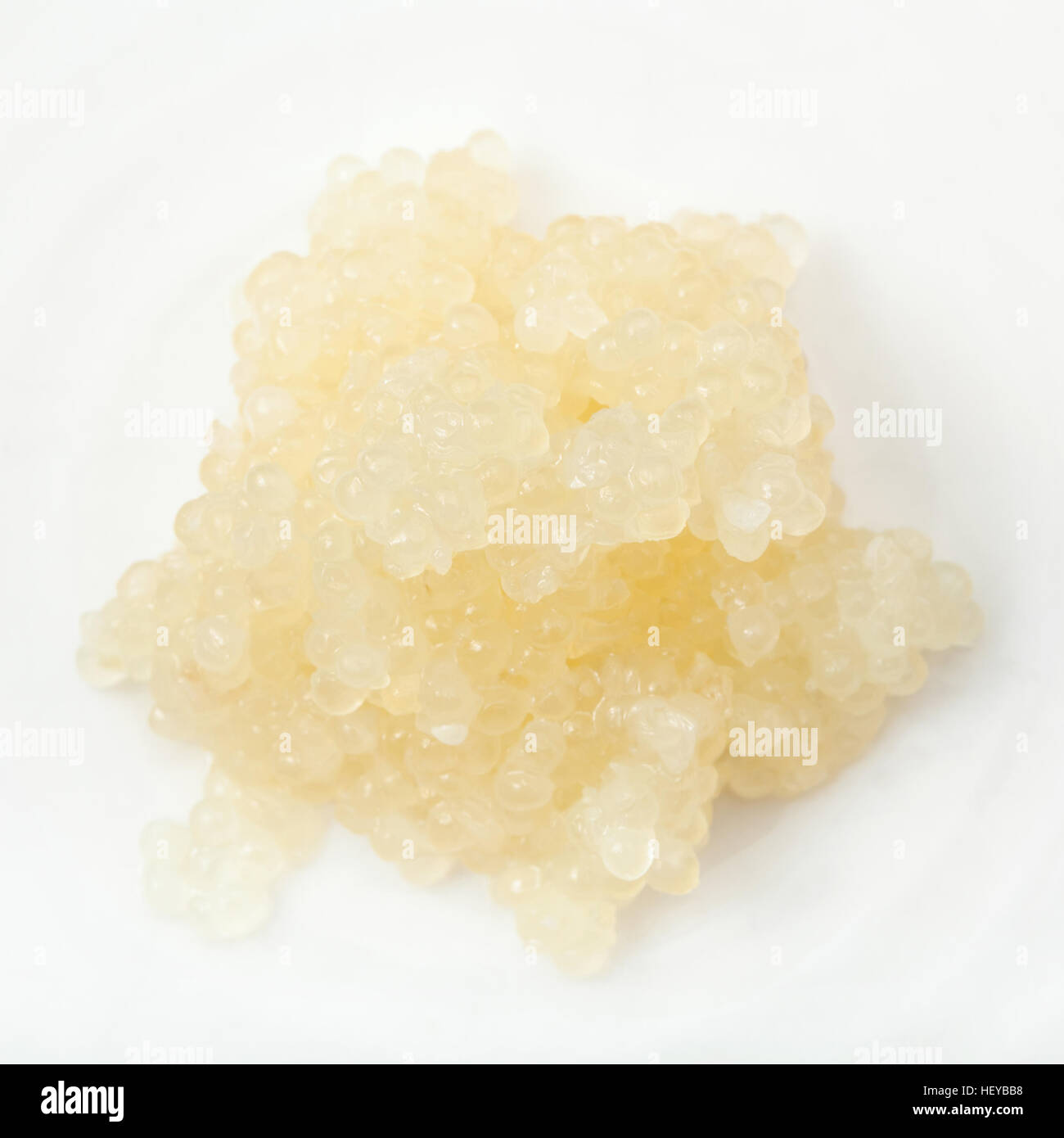 handful of salty caviar of halibut fish on white plate Stock Photo