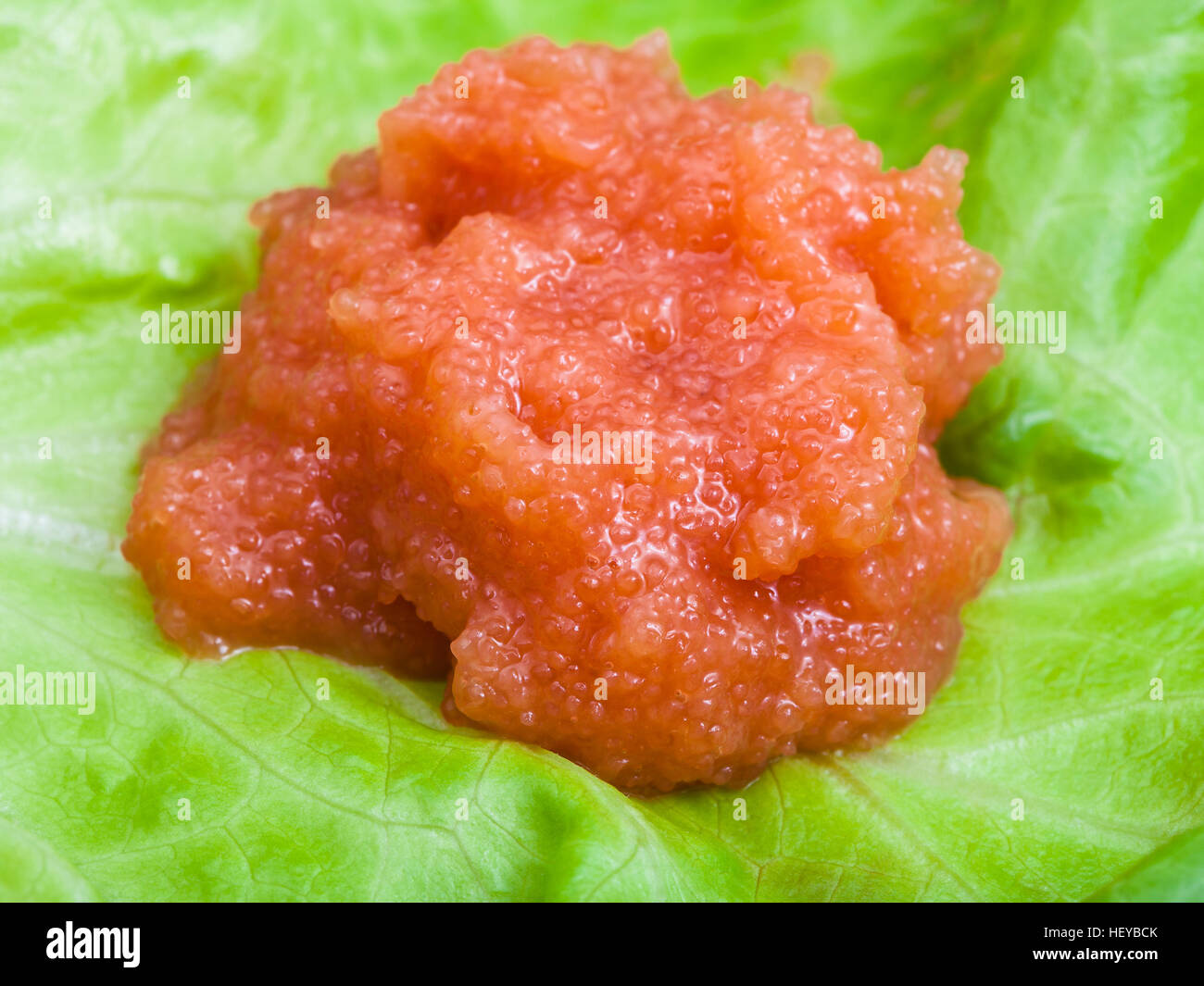 portion of salty caviar of coregonus whitefish on green leaf Stock Photo