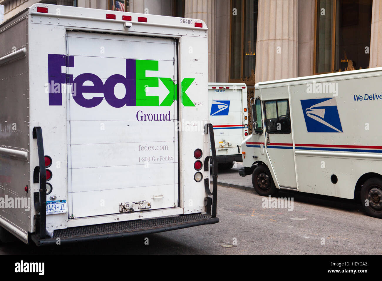 New York,USA July 29, 2013 FedEx and USPS cars on the same street in
