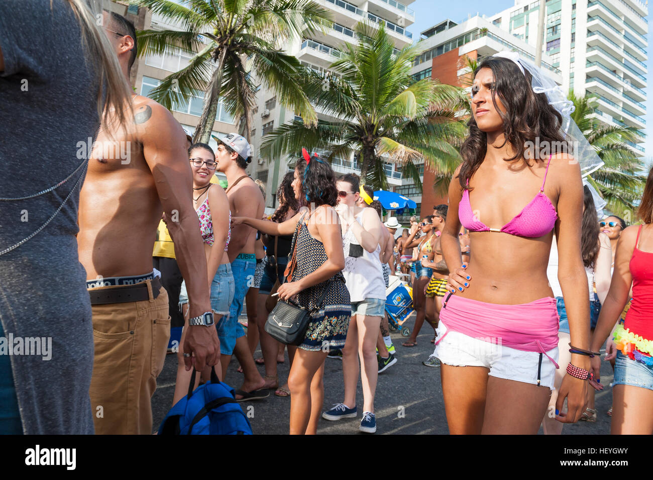 RIO DE JANEIRO - FEBRUARY 14, 2015: Vendors and revelers share the Ipanema beachfront at a Carnival street party. Stock Photo