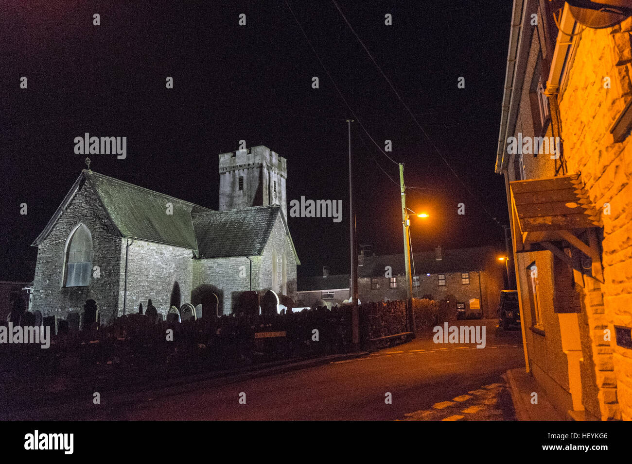 Floodlit, lit up Llansaint church in centre of Llansaint village. A quaint typical Welsh hilltop village above Carmarthen Bay. Stock Photo