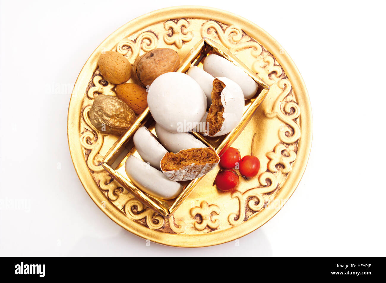 Golden plate of spice nuts, rose hips and nuts Stock Photo