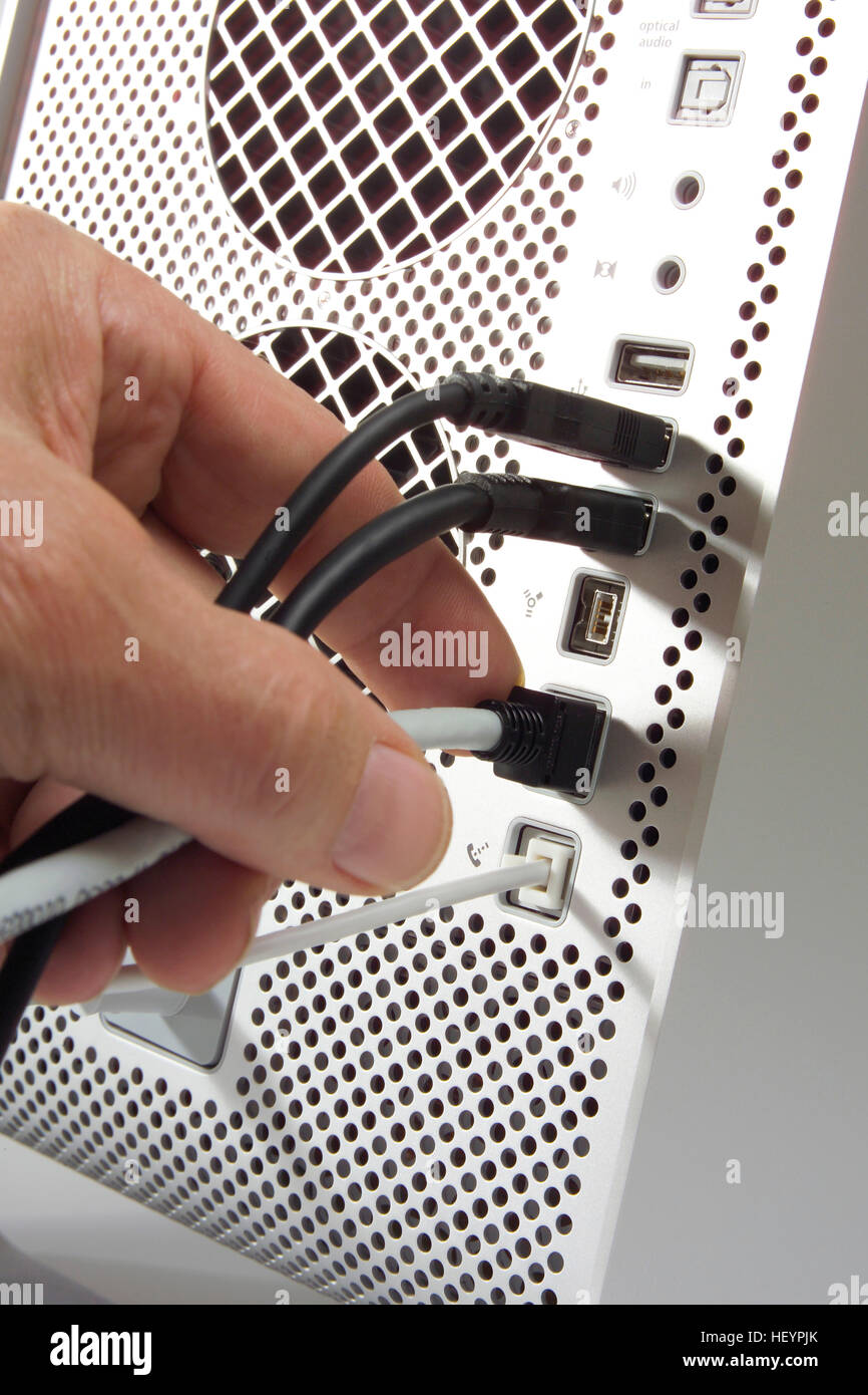 Sticking a plug into the computer Stock Photo Alamy