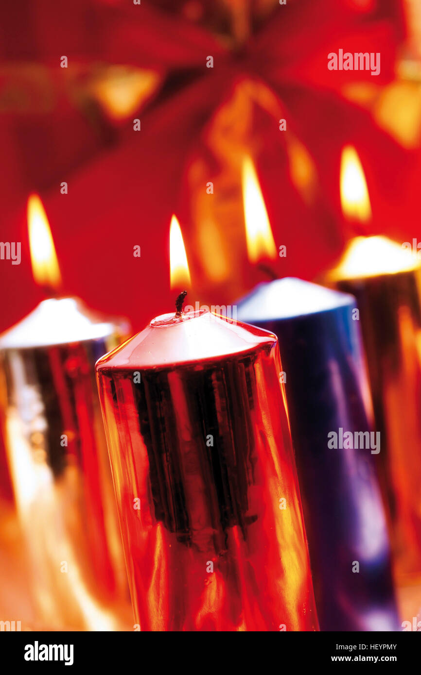 Burning candles, lit candles, different metallic colours Stock Photo