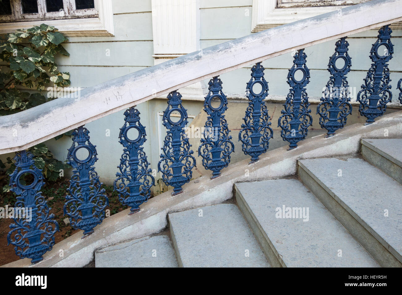 Modern blue wrought iron railing with stone steps Stock Photo