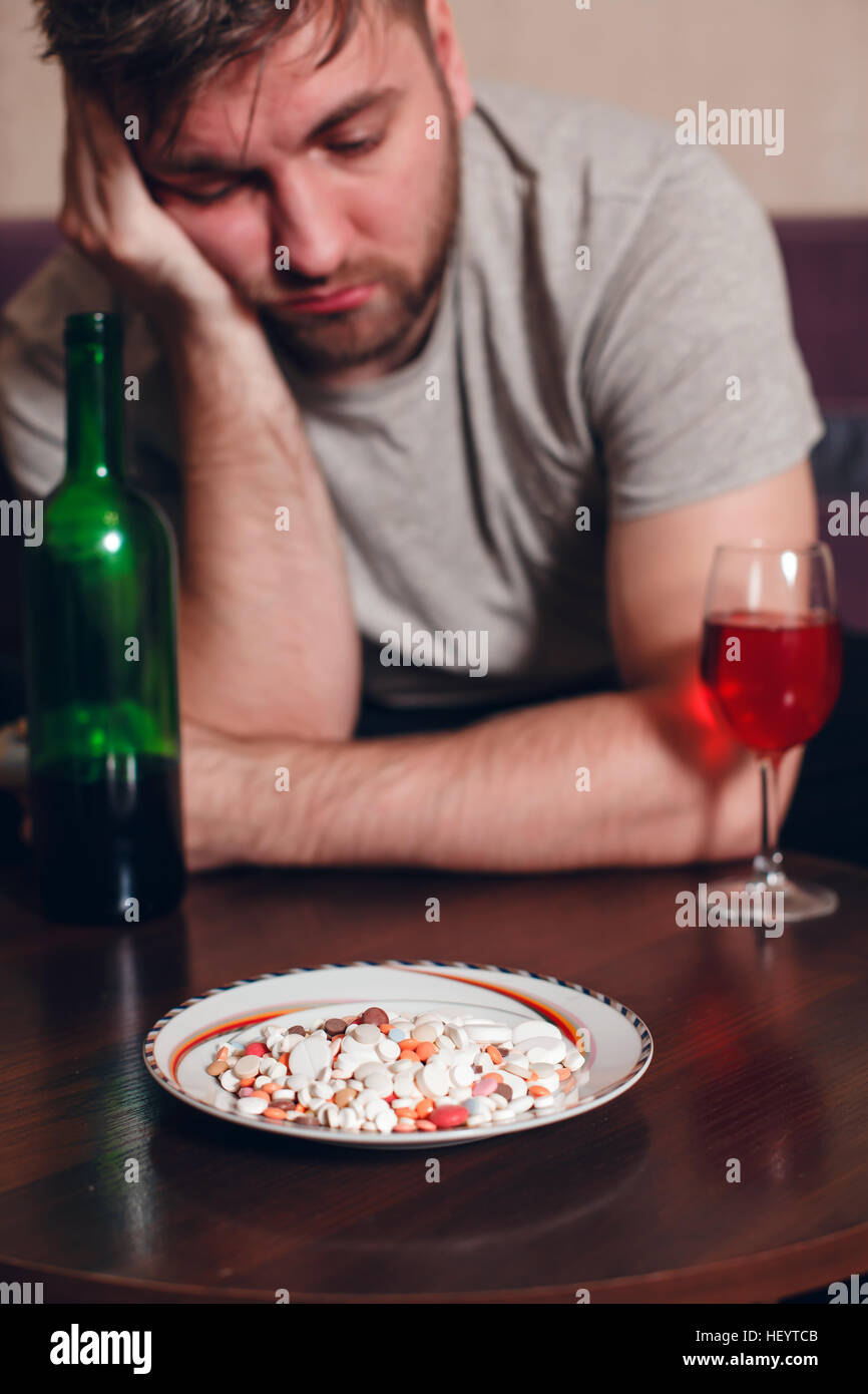 Alcohol addicted man has fallen asleep at a table Stock Photo