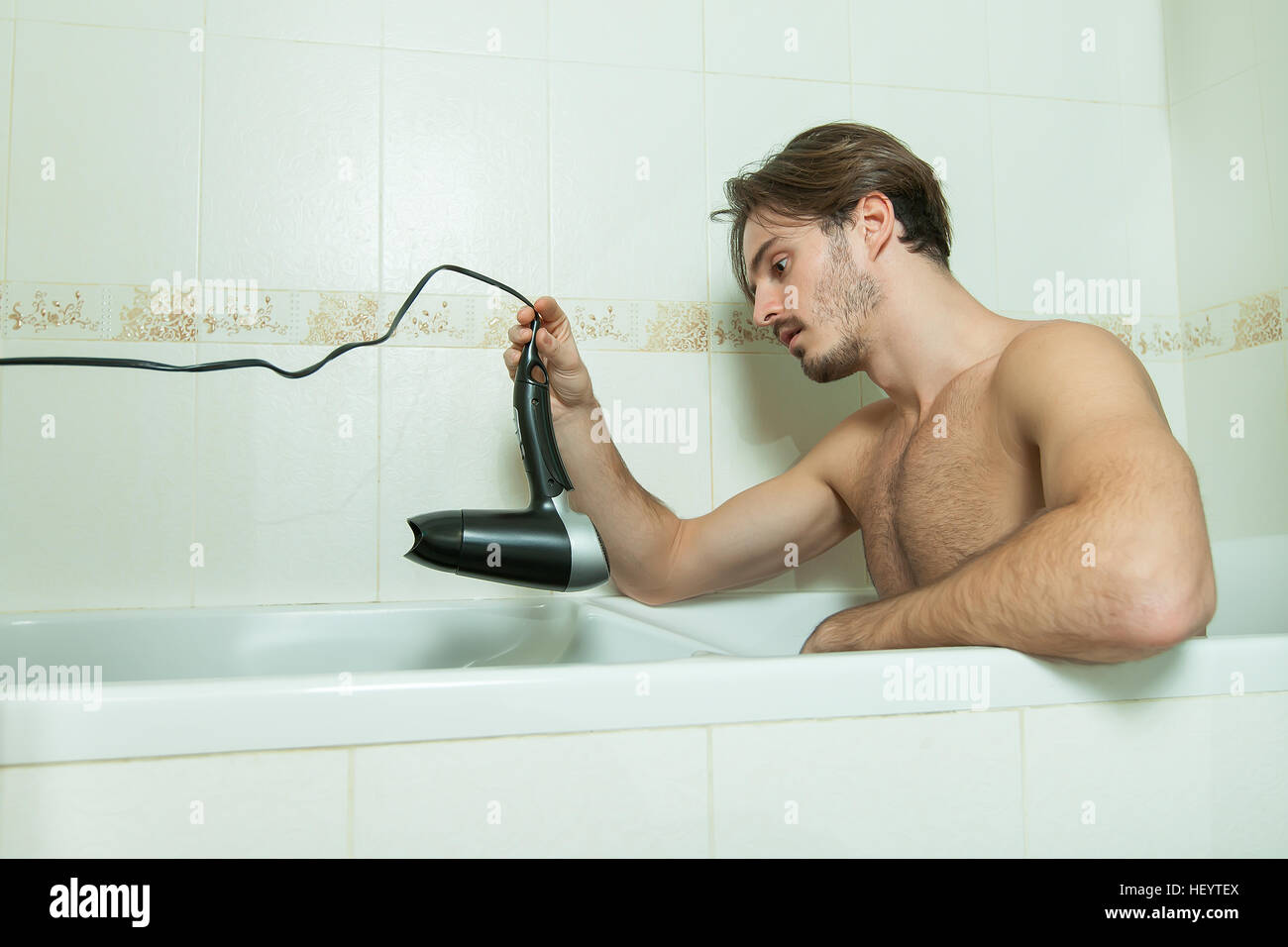 Hairdryer bath danger hi-res stock photography and images - Alamy