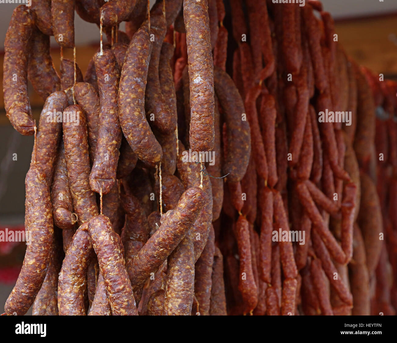 https://c8.alamy.com/comp/HEYTFN/cured-smoked-dried-assorted-homemade-artisan-red-pork-meat-sausages-HEYTFN.jpg