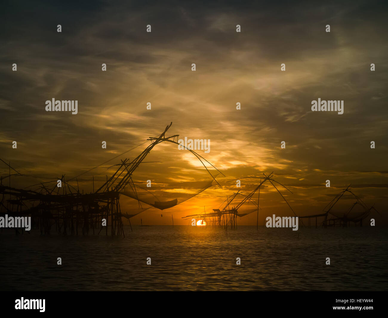 Sunrise and silhouette of fisherman at Thale Noi Waterfowl Park