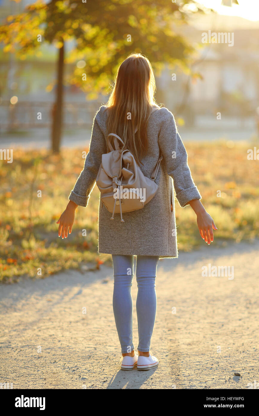 Beautiful girl standing at sunrise Stock Photo