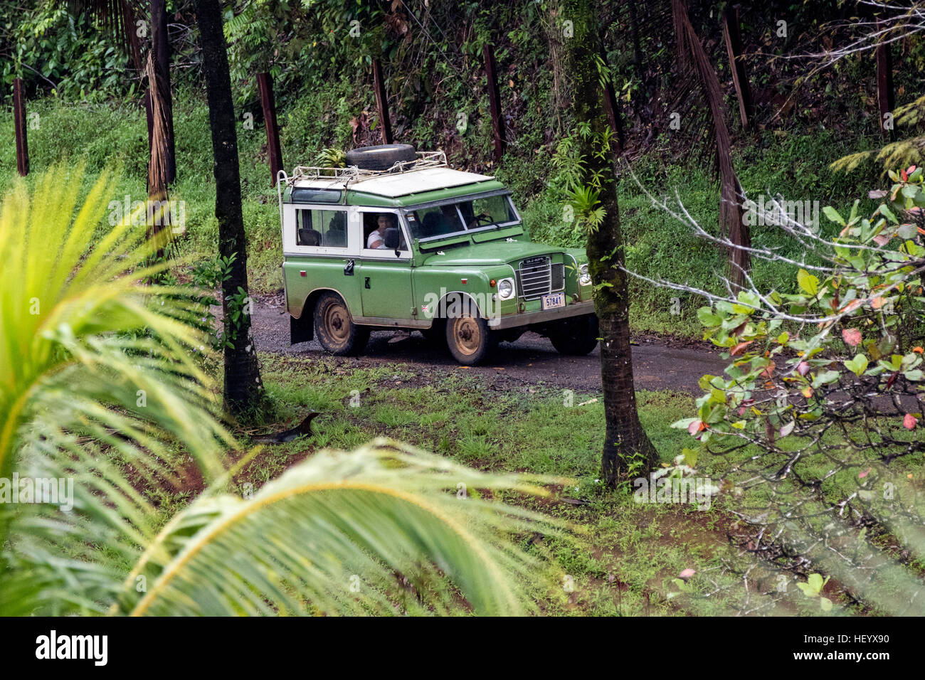 Land Rover Defender driving down dirt road - Laguna del Lagarto Lodge, Boca Tapada, Costa Rica Stock Photo