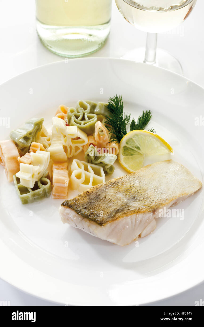Seafood dish: zander filet with pasta and dill salad and white wine Stock Photo