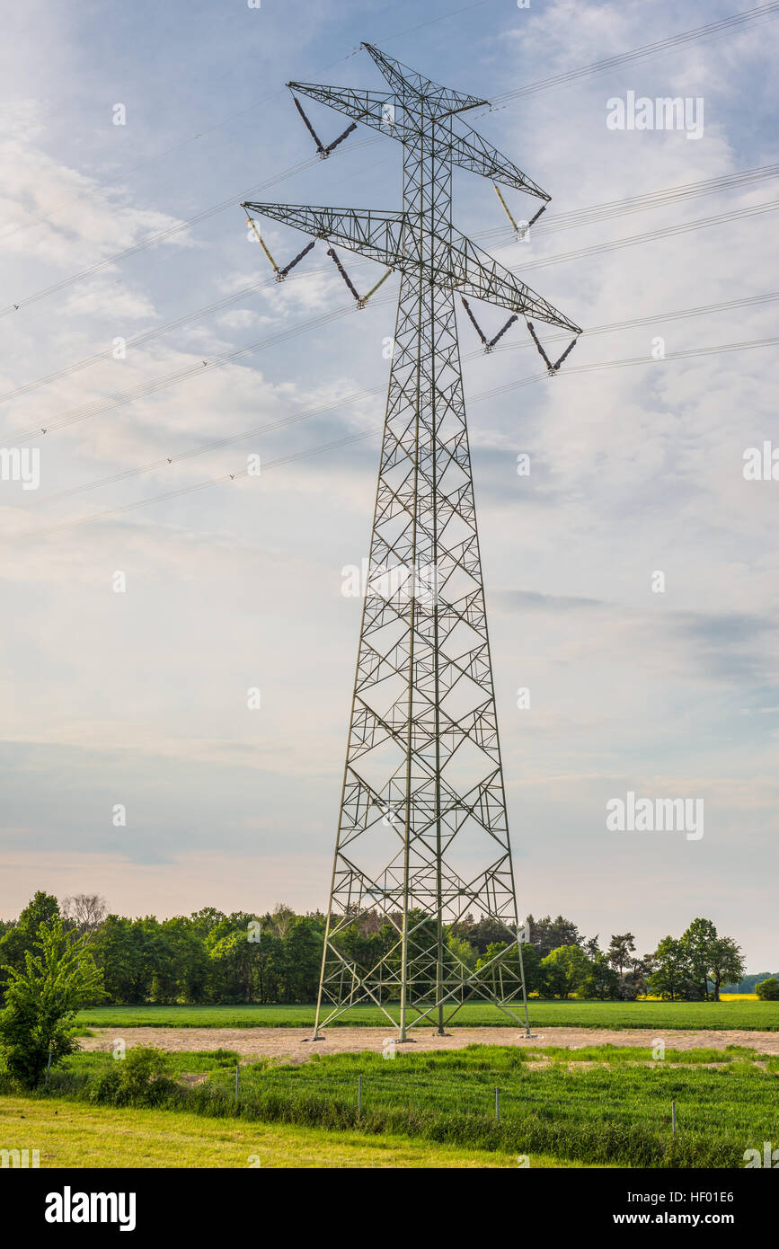 High-voltage power line metal tower with wires vertical view Stock Photo