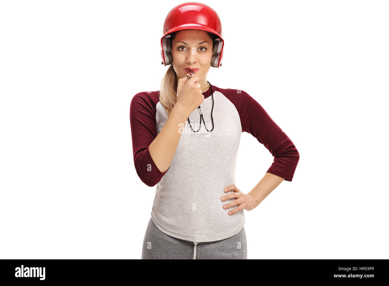 Female baseball coach blowing a whistle isolated on white background