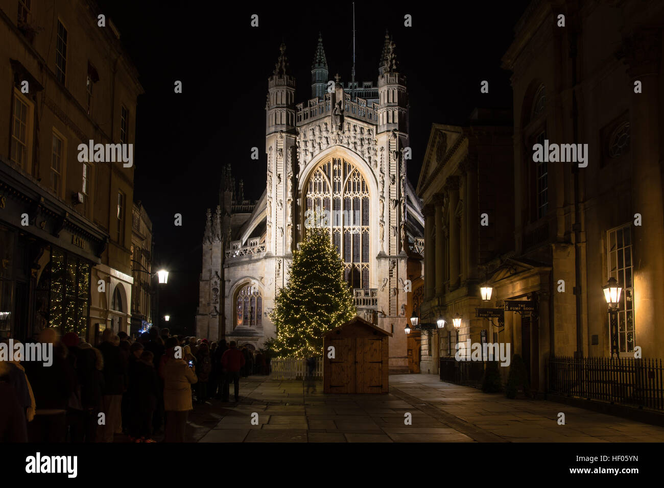 People queue for Christmas Midnight Mass at Bath Abbey. Hundreds line up ahead of religious service to celebrate Christmas mass Stock Photo