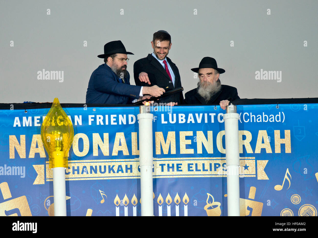 Under Secretary of the Treasury on Countering the Financing of Terrorism Adam Szubin (Acting), center, accompanied by Rabbi Levi Shemtov, Executive Vice President of American Friends of Lubavitch (Chabad), left, and Rabbi Abraham Shemtov, Chairman of the Board of Agudas Chasidei Chabad and founding director of American Friends of Lubavitch (Chabad), right, light the National Menorah on the White House Ellipse in Washington, DC on Sunday, December 25, 2016. Credit: Bill Auth/CNP /MediaPunch Stock Photo