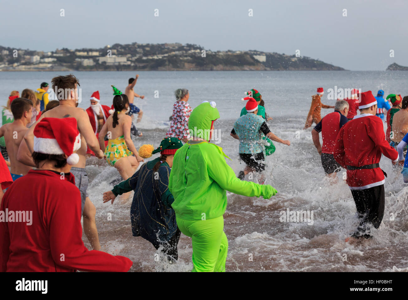 Paignton, Devon, UK, 26 December 2016. Paignton 'Walk in to the Sea', Boxing Day Dip. The annual Boxing Day tradition, common to many coastal locations right across the UK, began in Paignton in 1976. Participants generally dress up in seasonal fancy dress and raise money for the Paignton Lions, who organise the event, and other charities. Credit: Clive Jones/Alamy Live News Stock Photo