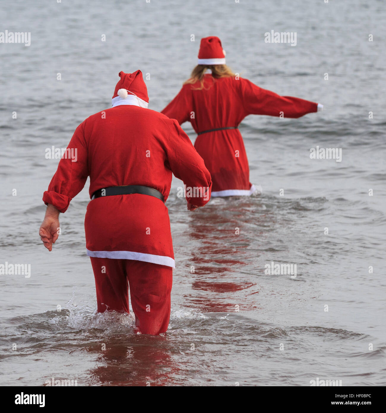 Paignton, Devon, UK, 26 December 2016. Paignton 'Walk in to the Sea', Boxing Day Dip. The annual Boxing Day tradition, common to many coastal locations right across the UK, began in Paignton in 1976. Participants generally dress up in seasonal fancy dress and raise money for the Paignton Lions, who organise the event, and other charities. Credit: Clive Jones/Alamy Live News Stock Photo