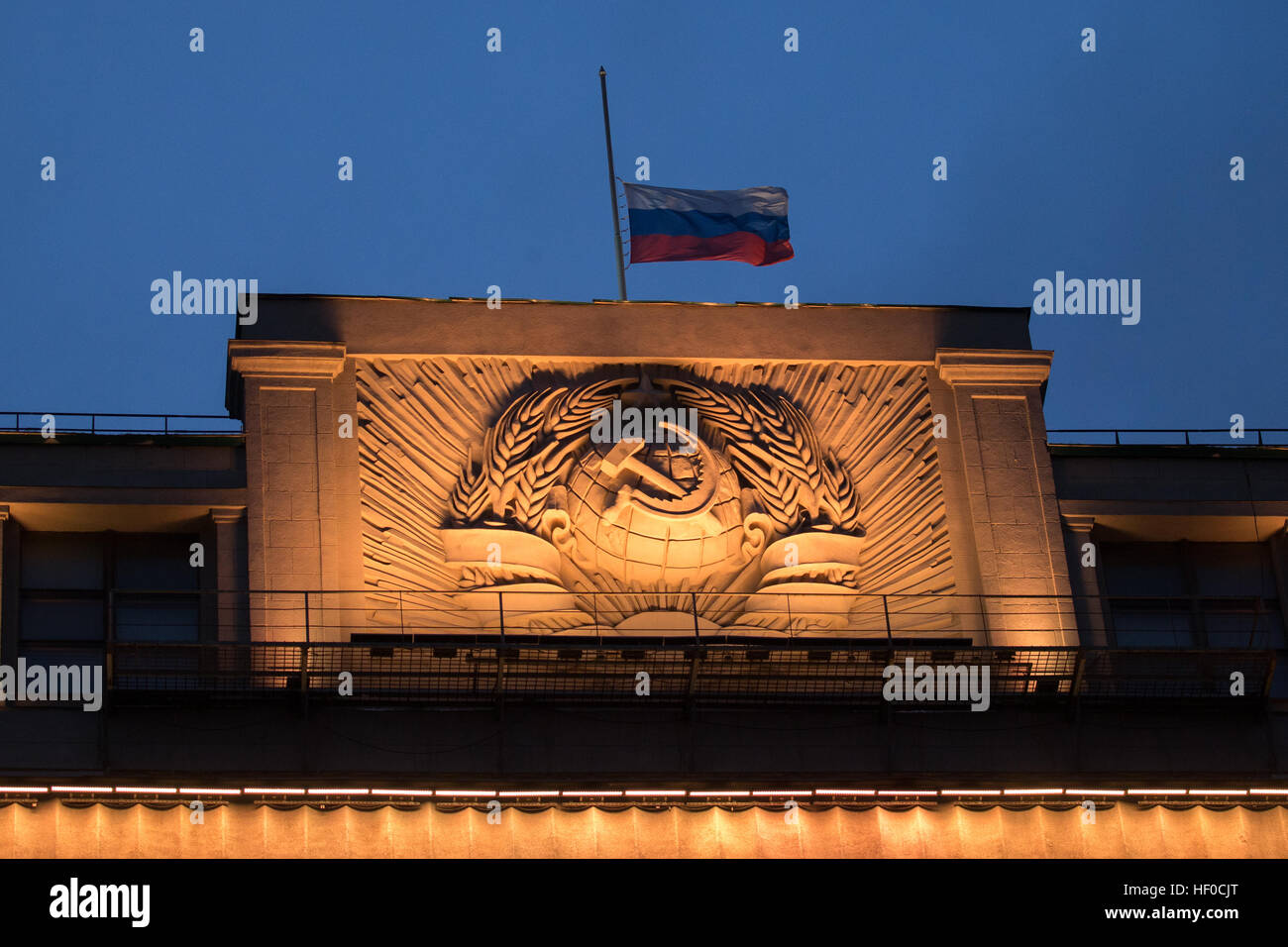 MOSCOW, RUSSIA - DECEMBER 26, 2016: A Russian flag flying at half-mast above the Russian State Duma building as Russia's President Vladimir Putin declares December 26, 2016 the Day of National Mourning for the victims of the Tupolev Tu-154 plane crash off Sochi coastline a day earlier. The plane of Russia's Defence Ministry bound for Russia's Hmeymim air base in Syria, was carrying members of the Alexandrov Ensemble, Russian servicemen and journalists, and Yelizaveta Glinka (known as Doctor Liza), Spravedlivaya Pomoshch [Just Aid] International Public Organisation director. Stock Photo