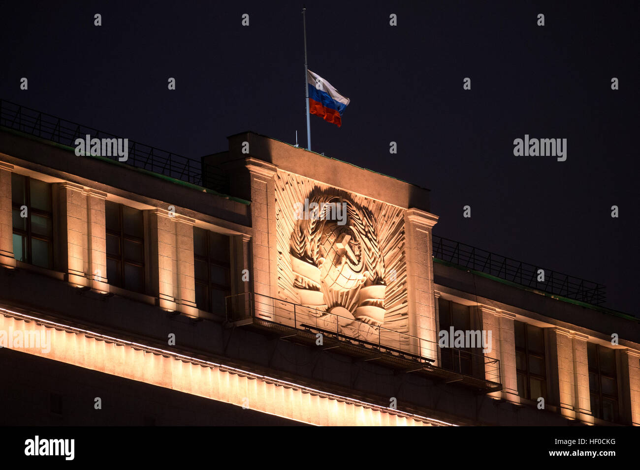 MOSCOW, RUSSIA - DECEMBER 26, 2016: A Russian flag flying at half-mast above the Russian State Duma building as Russia's President Vladimir Putin declares December 26, 2016 the Day of National Mourning for the victims of the Tupolev Tu-154 plane crash off Sochi coastline a day earlier. The plane of Russia's Defence Ministry bound for Russia's Hmeymim air base in Syria, was carrying members of the Alexandrov Ensemble, Russian servicemen and journalists, and Yelizaveta Glinka (known as Doctor Liza), Spravedlivaya Pomoshch [Just Aid] International Public Organisation director. Stock Photo