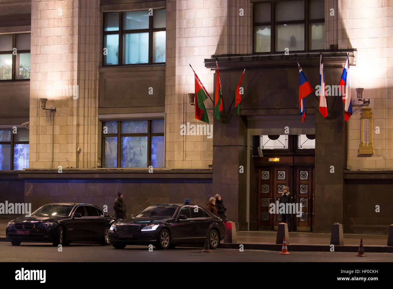 MOSCOW, RUSSIA - DECEMBER 26, 2016: Russian and Moscow flags flying with black ribbons outside the Russian State Duma building as Russia's President Vladimir Putin declares December 26, 2016 the Day of National Mourning for the victims of the Tupolev Tu-154 plane crash off Sochi coastline a day earlier. The plane of Russia's Defence Ministry bound for Russia's Hmeymim air base in Syria, was carrying members of the Alexandrov Ensemble, Russian servicemen and journalists, and Yelizaveta Glinka (known as Doctor Liza), Spravedlivaya Pomoshch [Just Aid] International Public Organisation director. Stock Photo