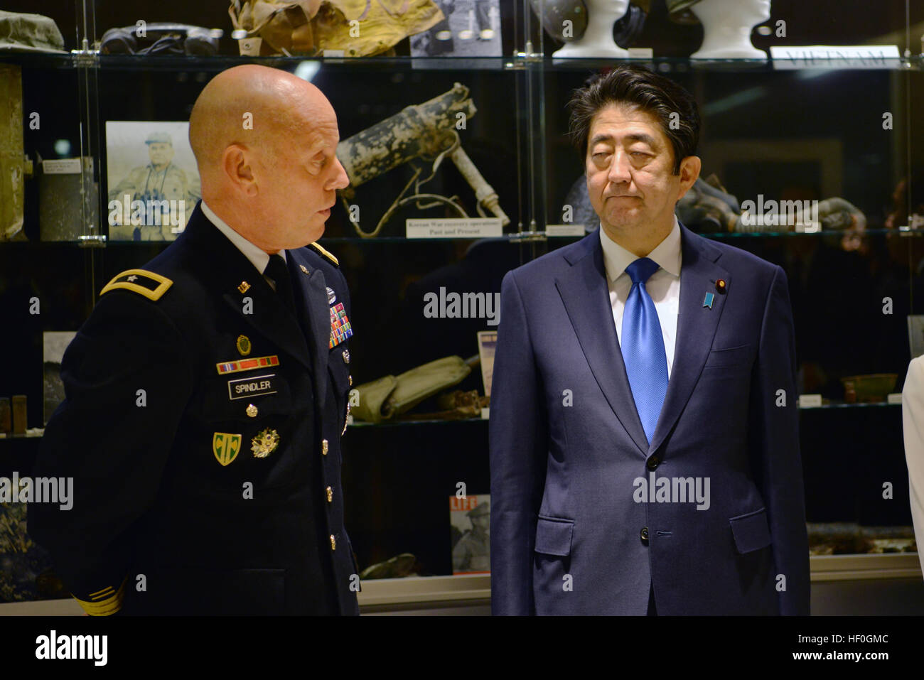 Japanese Prime Minister Shinzo Abe, left, is briefed by Deputy Director U.S. Army Brig. Gen. Mark Spindler, during a tour of the laboratory at the Defense POW/MIA Accounting Agency facility December 26, 2016 in Pearl Harbor, Hawaii. Abe is the first Japanese leader to publicly view the site of the Pearl Harbor Attack. Stock Photo