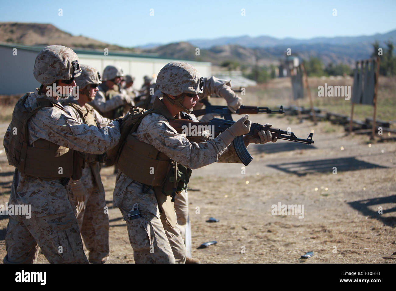 Lance Cpl. Justin Vandershaaf, a rifleman with 1st Battalion, 25th Marines Regiment, Alpha Company, loads and prepares to fire an AK-47 assault rifle during a foreign weapons course with the Advisor Training Group at Range 314 here, June 30. The training gives Marines a basic understanding of weapons like the Singular Valve Decompression Rifle, Kalashnikov’s Machinegun-Modernized rifle and the AK-47. The Marines are preparing for an upcoming deployment where they will be working closely with the Afghan police and military. Advisor Training Group instructs foreign weapons course 110630-M-BT412- Stock Photo