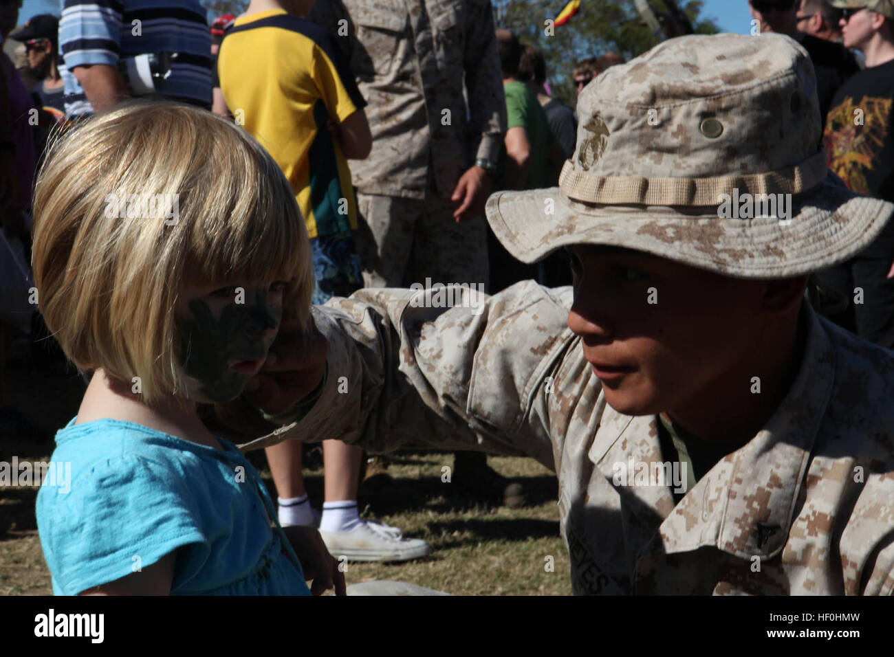 Sommer Hugh, 2, from Rockhampton, Australia, gets her face painted with