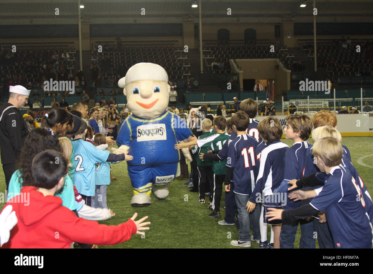 The San Diego Sockers mascot runs through a line of youth soccer players  during the San Diego Sockers entrance to the field before their game  against the Tacoma Stars at Del Mar