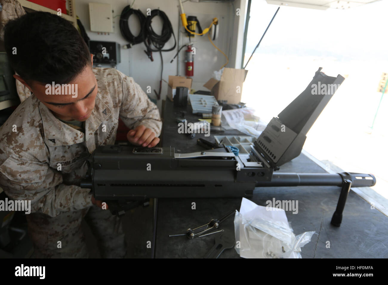 U.S. Marine Lance Cpl. Nicholas H. Schlienz cleans the barrel of a Mark-19 40 millimeter grenade launcher Apr. 6 at Gwangyang Port, Republic of Korea during exercise Freedom Banner 2014. Freedom Banner 14 is a maritime prepositioning force offloading exercise that enables amphibious assault exercise Ssang Yong 14. As Ssang Yong 14 concludes, the gear used in the amphibious assault is returned to the Freedom Banner 14 area of operations and prepped for the final back load of gear onto the USNS 2nd Lt. John P. Bobo. Schlienz is an armorer with 3rd Combat Assault Battalion, 3rd Marine Division, I Stock Photo