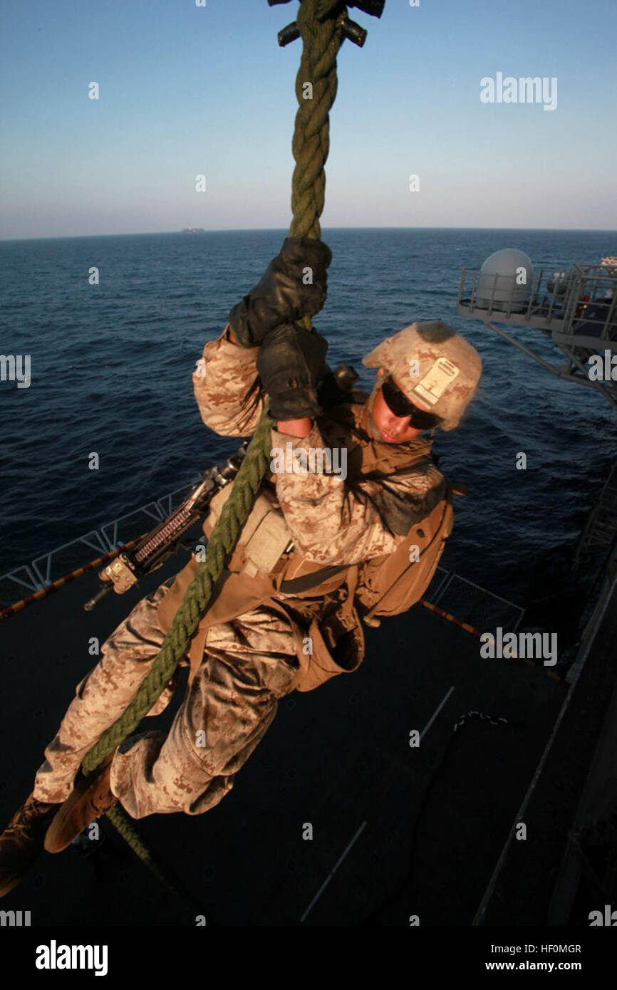 A U.S. Marine with India Company, Battalion Landing Team 3rd Battalion, 1st Marine Regiment descends 35 feet down a plaited rope rigged to a CH-46 Sea Knight helicopter aboard amphibious assault ship USS Makin Island (LHD 8) Jan. 8, 2012, in the Arabian Sea. Battalion Landing Team 3/1, the 11th Marine Expeditionary Unit's ground combat element, was deployed as part of the Makin Island Amphibious Ready Group. The group also provided support for maritime security operations and theater security cooperation efforts in the U.S. 5th Fleet area of responsibility. (U.S. Marine Corps photo by Lance Cp Stock Photo