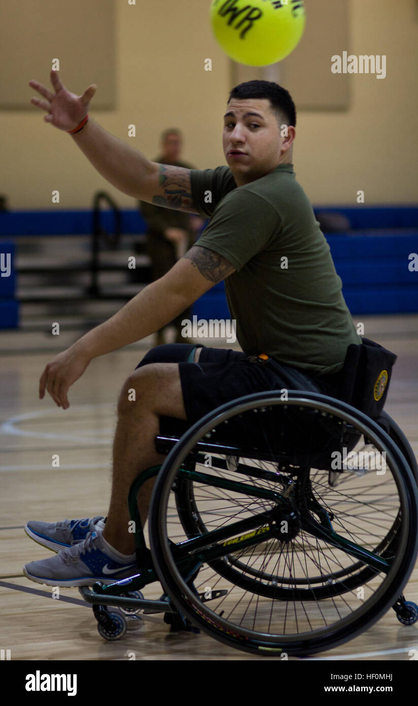 Cpl. Dominic Devila, whose truck was hit by an improvised explosive devise in Afghanistan, throws the ball to the goal during an improvised wheelchair soccer game at the Walter Reed National Military Medical Center Bethesda, Md., Jan. 10. Devila is one of 17 Marines who recently graduated from the first corporals course for the Wounded Warrior Detachment. Wounded Warrior Marines still in the fight 120110-M-AR635-007 Stock Photo